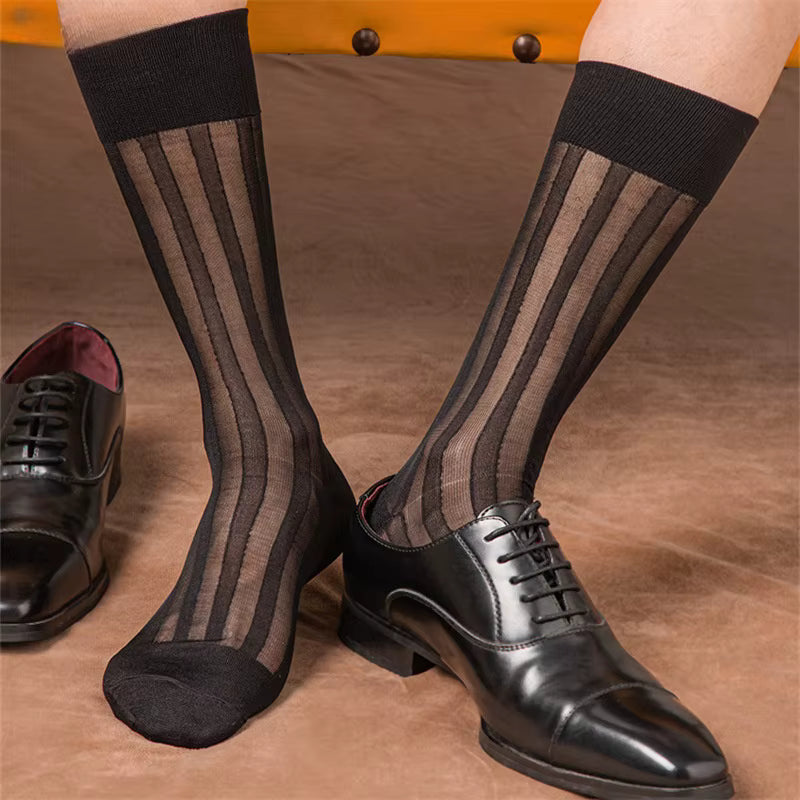 Black striped socks worn with black dress shoes on a brown surface